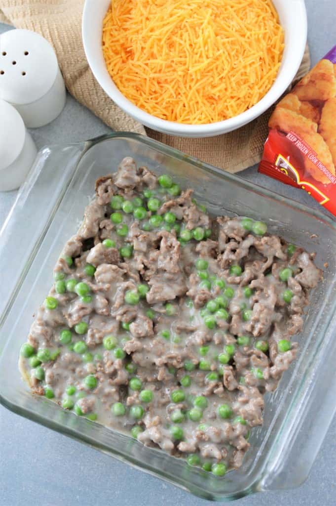 ground beef, cream of mushroom soup and frozen peas mixed and layered in baking dish