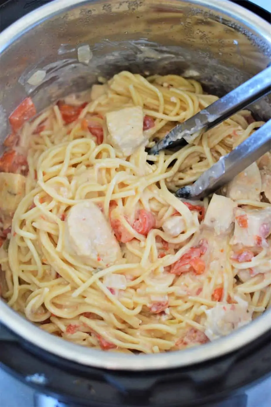 cooked chicken spaghetti being stirred in an Instant Pot