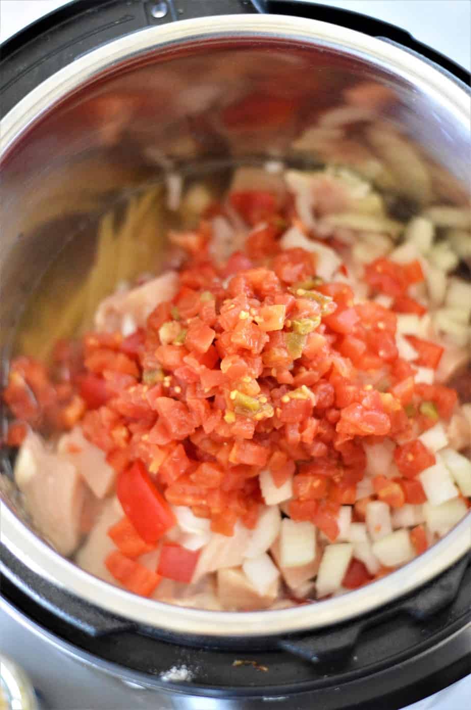 diced tomatoes with green chilis added to instant pot with chicken spaghetti ingredients