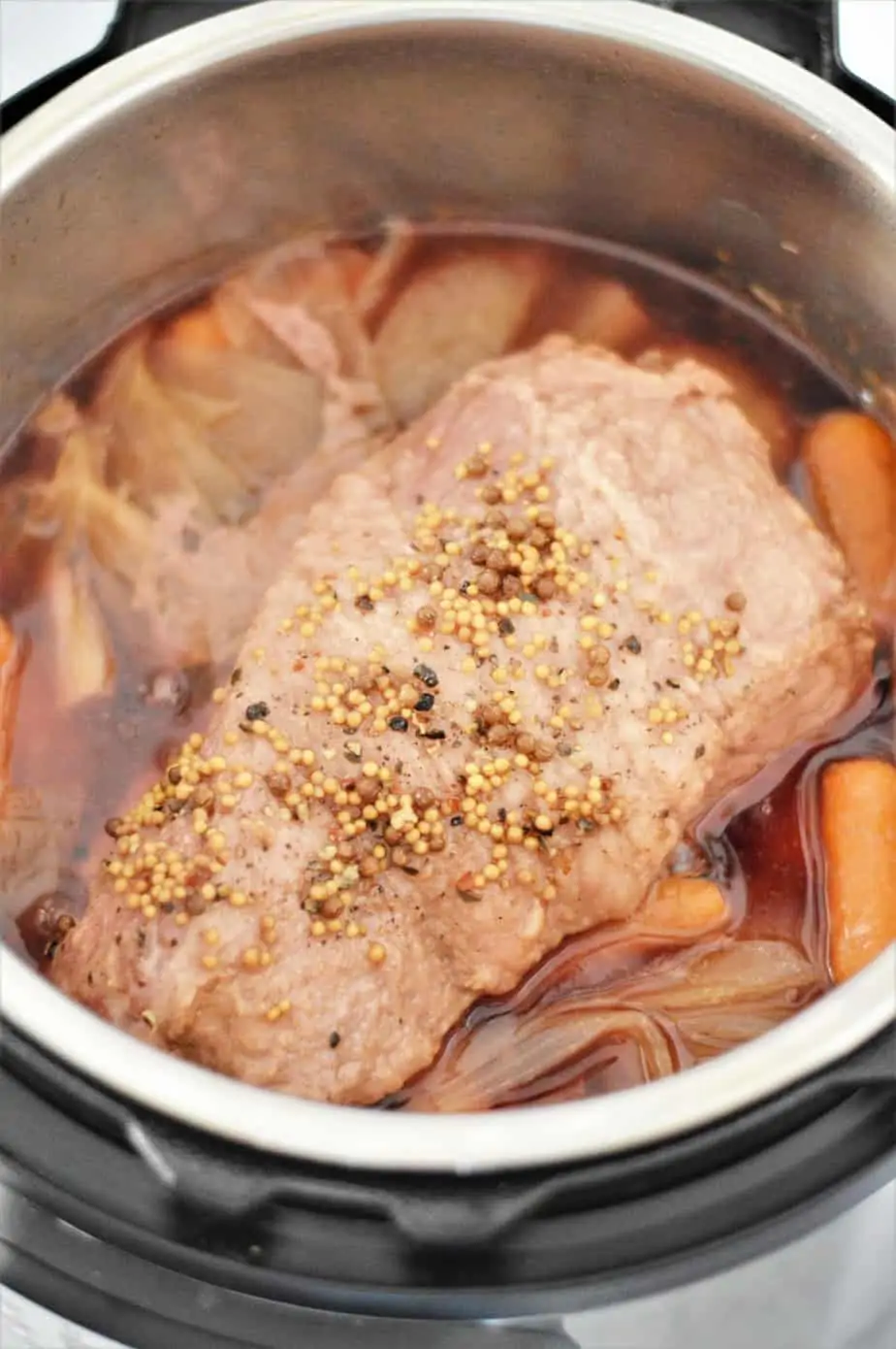 cooked corned beef in instant pot with carrots and onions