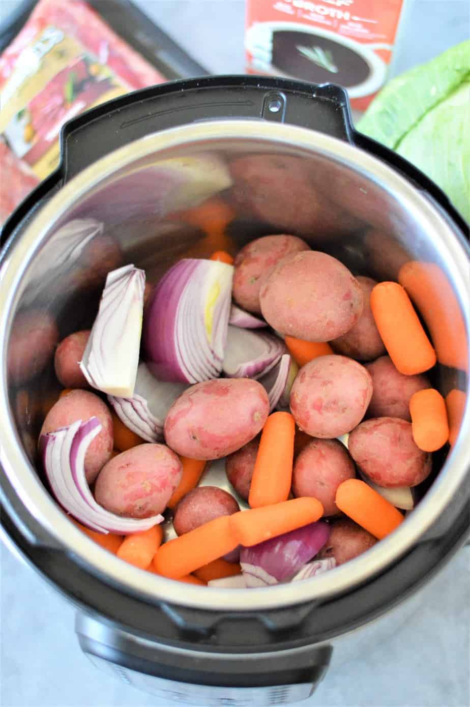 sliced onions, carrots and potatoes in instant pot