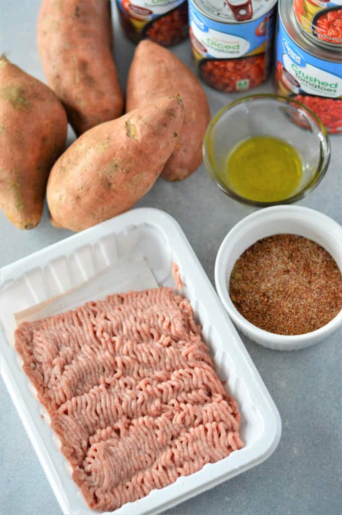 ingredients for turkey sweet potato chili: ground turkey, sweet potatoes, diced tomatoes, oil and spices