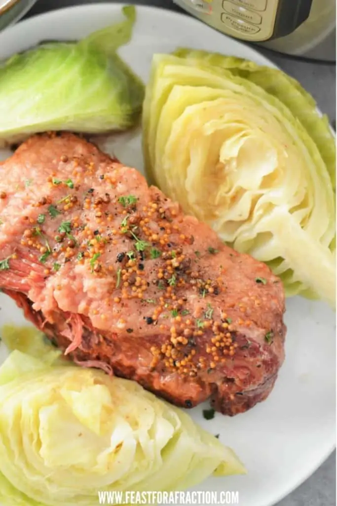 overhead view of cooked corned beef on white plate with instant pot in background