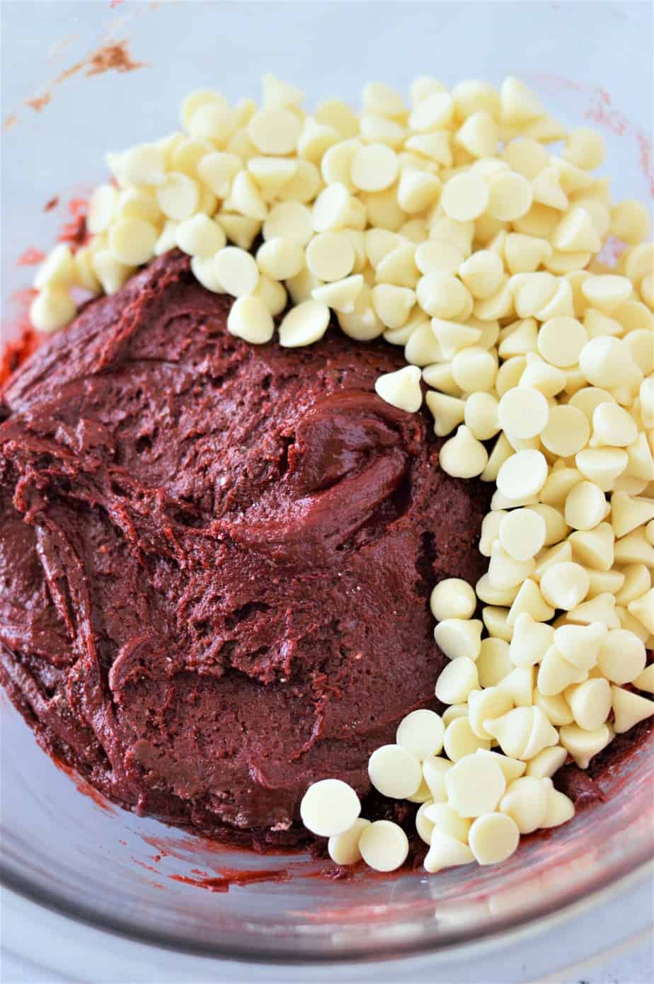 red velvet cake mix cookie dough with white chocolate chips in glass bowl