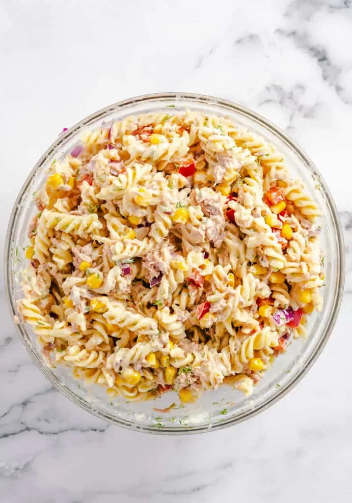 overhead view of tuna pasta salad in glass bowl