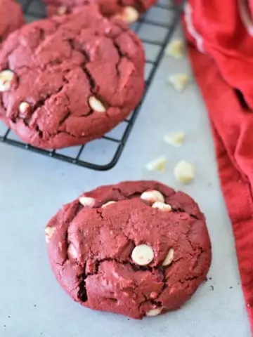 red velvet cake mix cookies on cooling rack with red cloth napkin