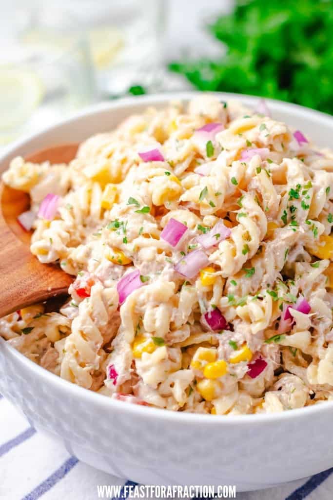 wooden spoon in bowl of tuna pasta salad