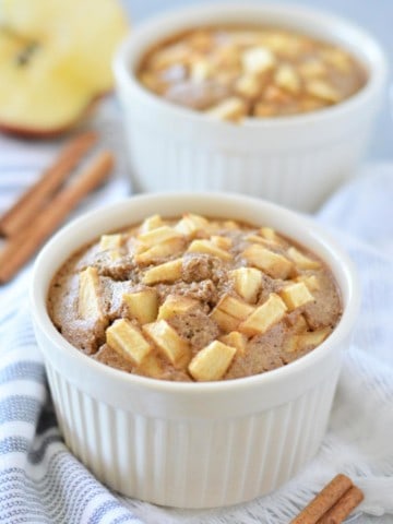 Ramekins of apple cinnamon blended oats on blue and white towel