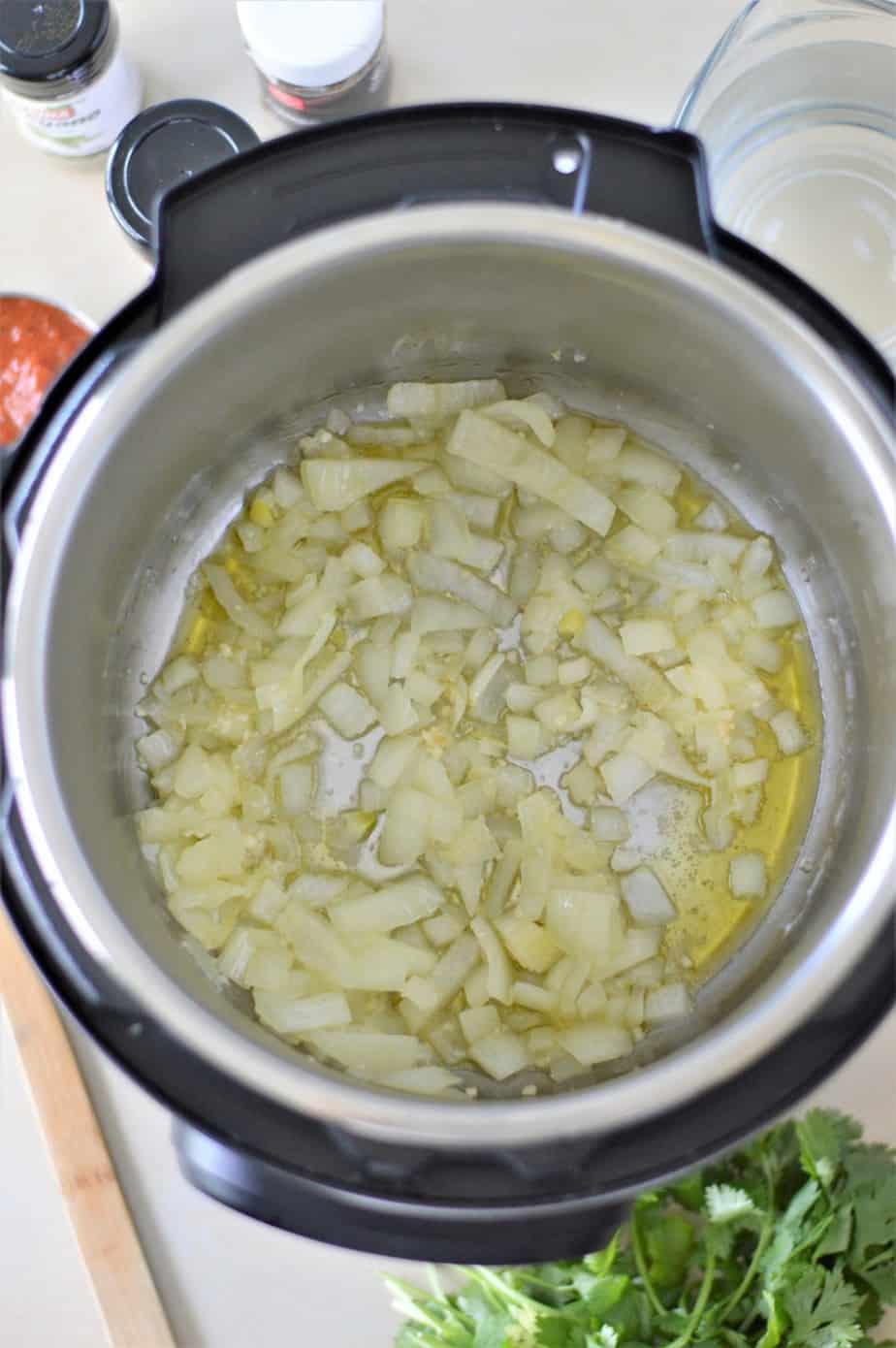 chopped onions in oil sauteing in Instant Pot