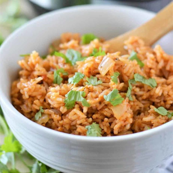 instant pot mexican rice in white bowl garnished with chopped cilantro