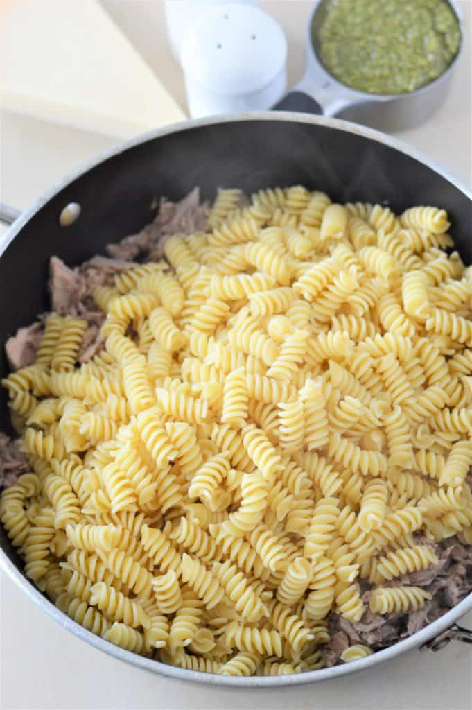 pasta added to pan with tuna and sauteed garlic