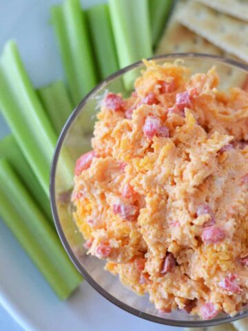 southern pimento cheese in bowl with celery sticks and saltine crackers