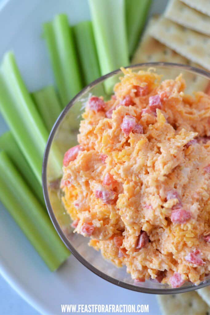 southern pimento cheese in bowl with celery sticks and saltine crackers