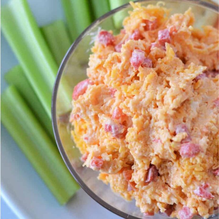 square image of prepared pimento cheese in bowl with celery sticks
