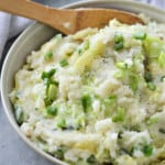 colcannon in bowl with wooden spoon
