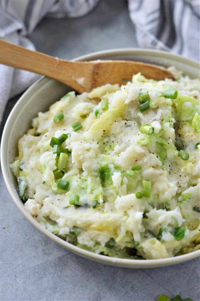 colcannon in bowl with wooden spoon