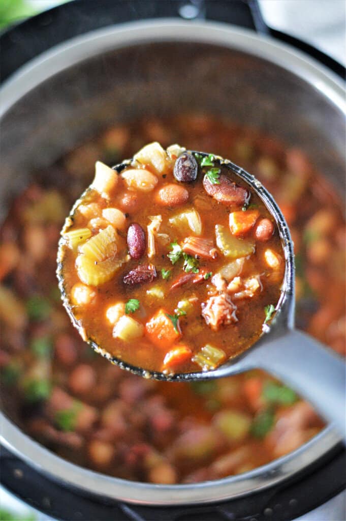 ladle with bean soup in instant pot
