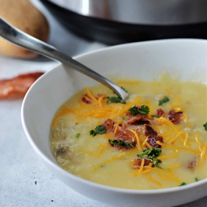 potato soup in bowl with spoon