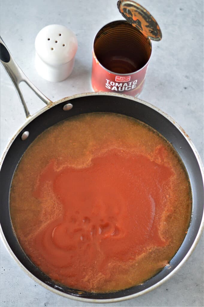 chicken broth and tomato sauce in skillet for enchilada sauce