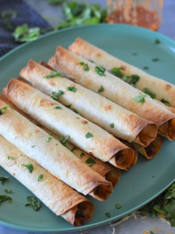 beef enchilada taquitos on plate ready to eat