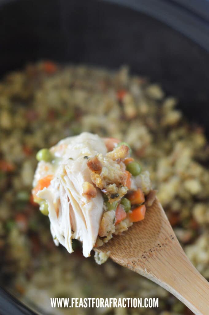 wooden spoon with crock pot chicken and stuffing