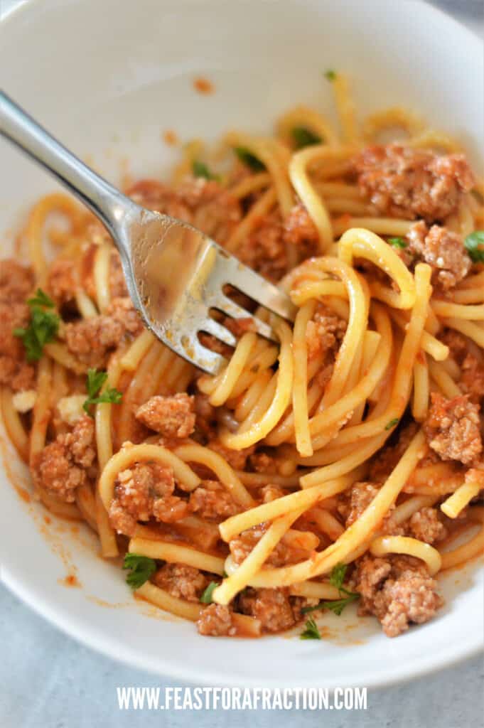 instant pot spaghetti on fork in white bowl