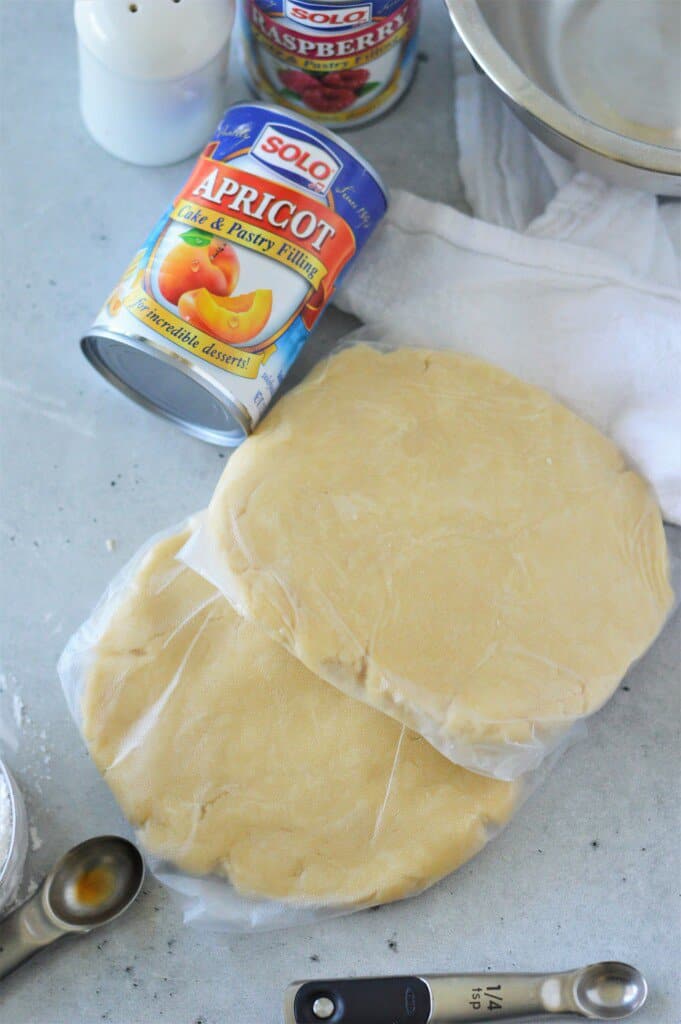 cream cheese pie dough formed into two disks wrapped in plastic wrap