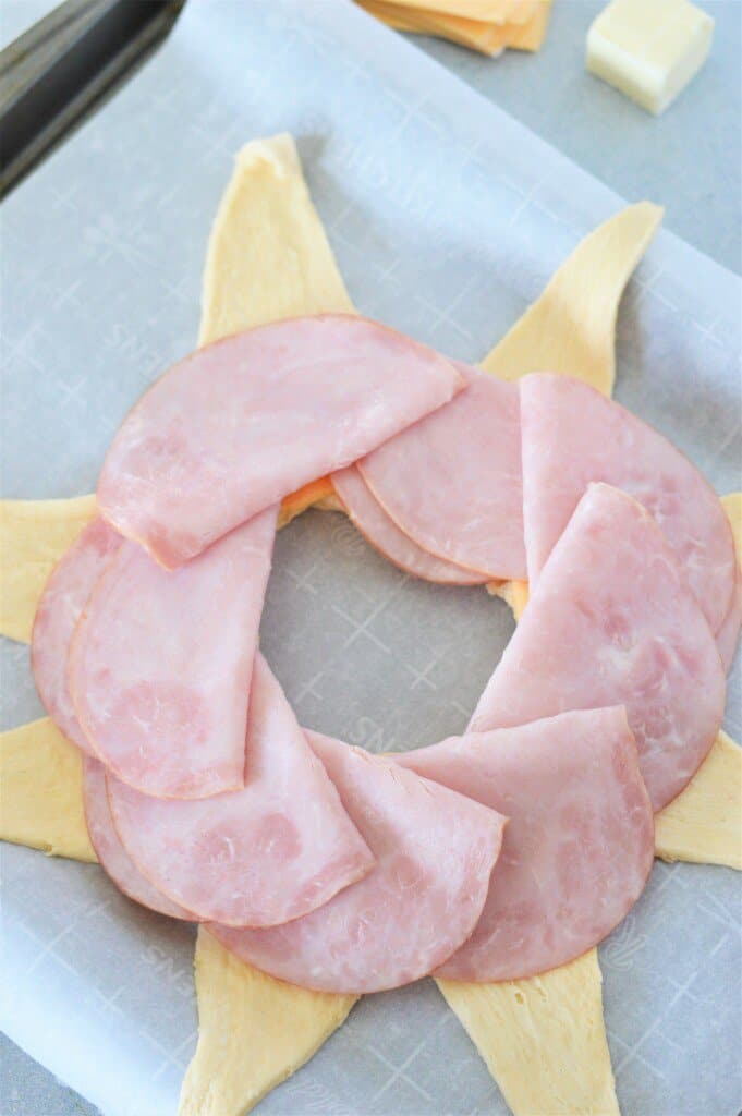 ham slices layered on crescent roll dough with cheese