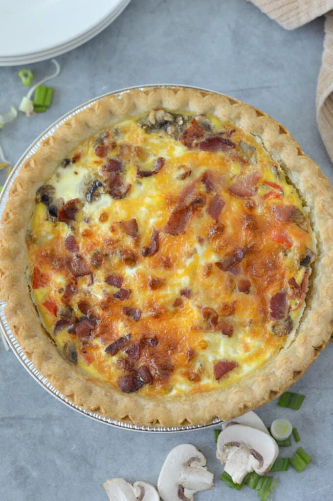 overhead view of baked quiche with mushrooms and green onions