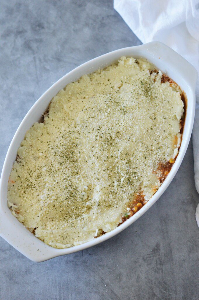 unbaked shepherd's pie in white oval baking dish