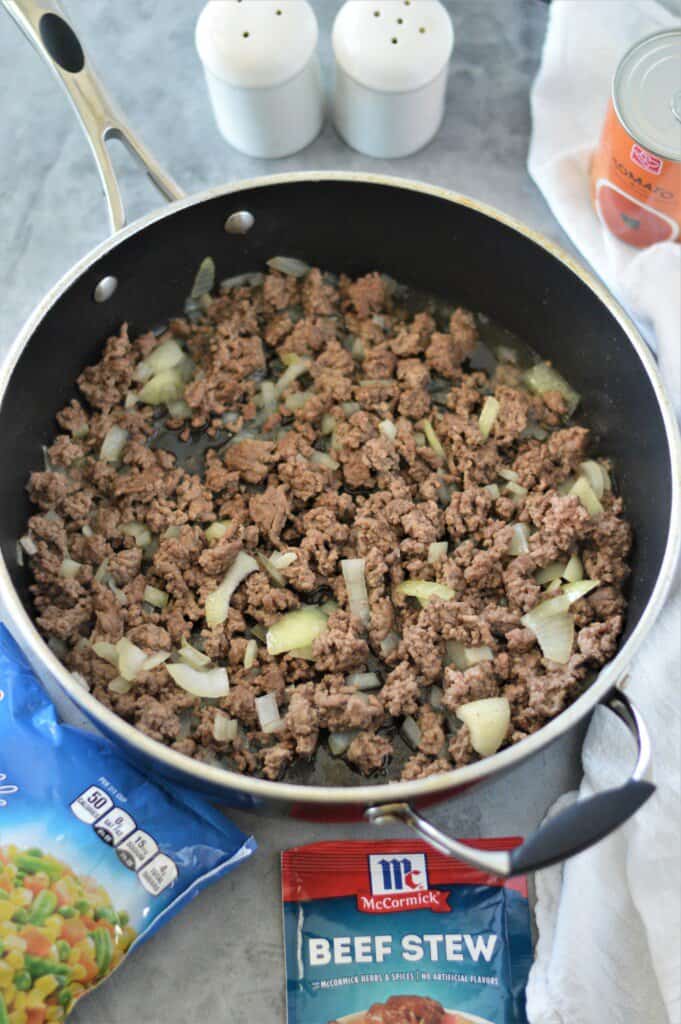 cooked ground beef and onions in pan