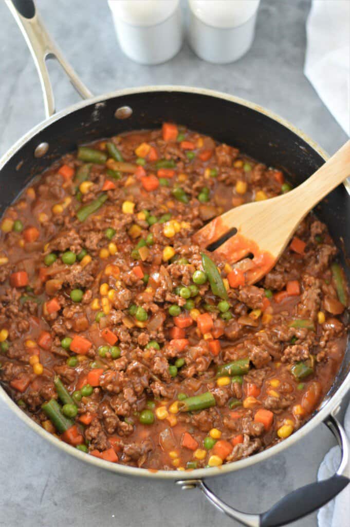 cooked ground beef, mixed vegetables and tomato soup in pan - shepherd's pie filling