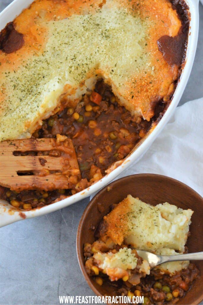 cottage pie in white baking dish and wooden bowl with fork
