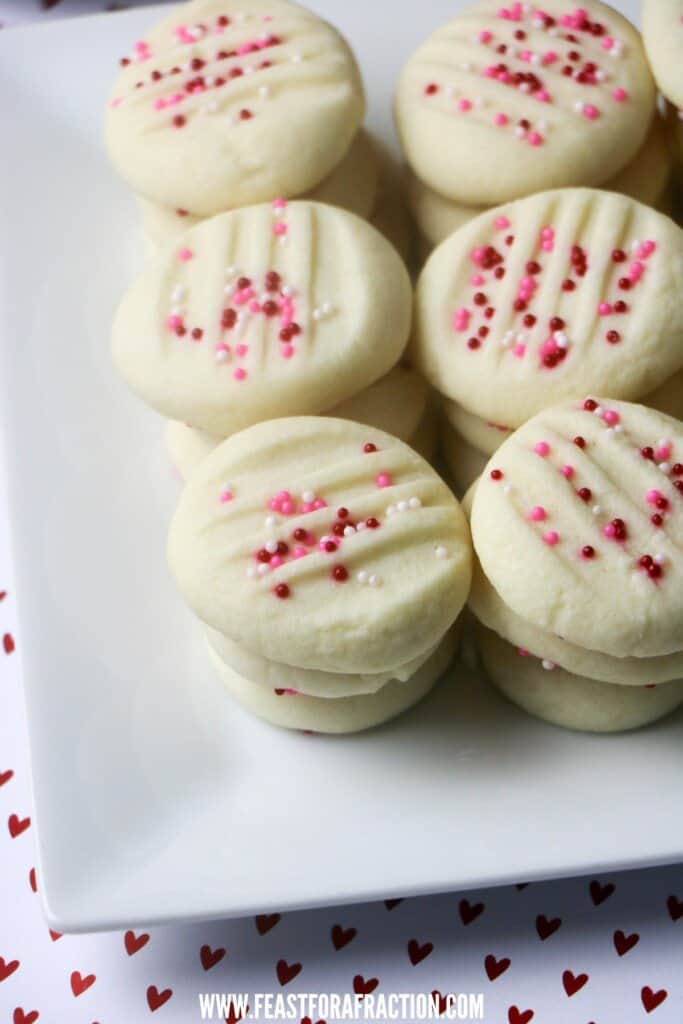 whipped shortbread cookies with valentine theme nonpareils on white platter