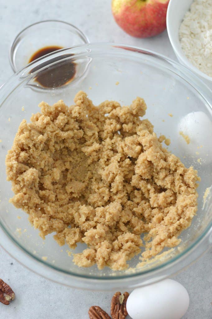 brown sugar and butter creamed in a glass bowl with ingredients in background
