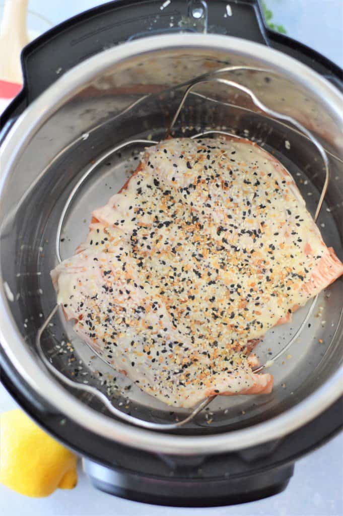 Salmon on a trivet in an instant pot topped with everything bagel seasoning