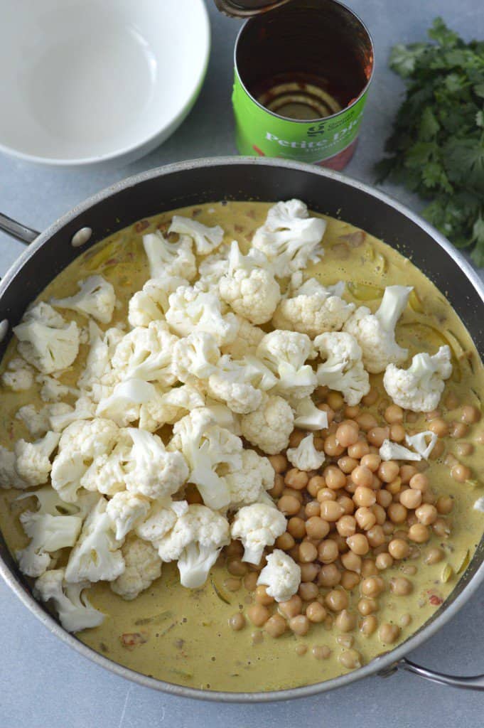 Cauliflower and chickpeas in a pan with coconut milk