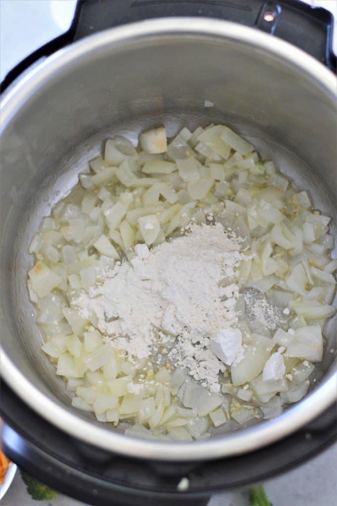 An instant pot filled with onions and flour.