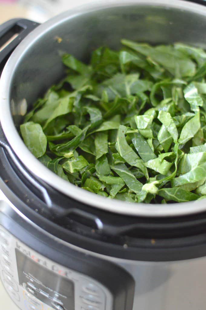 An instant pot filled with spinach.