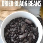 A bowl of cooked black beans with title text