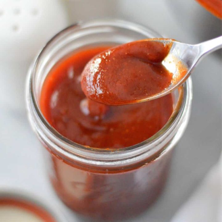 homemade bbq sauce in a mason jar with spoon
