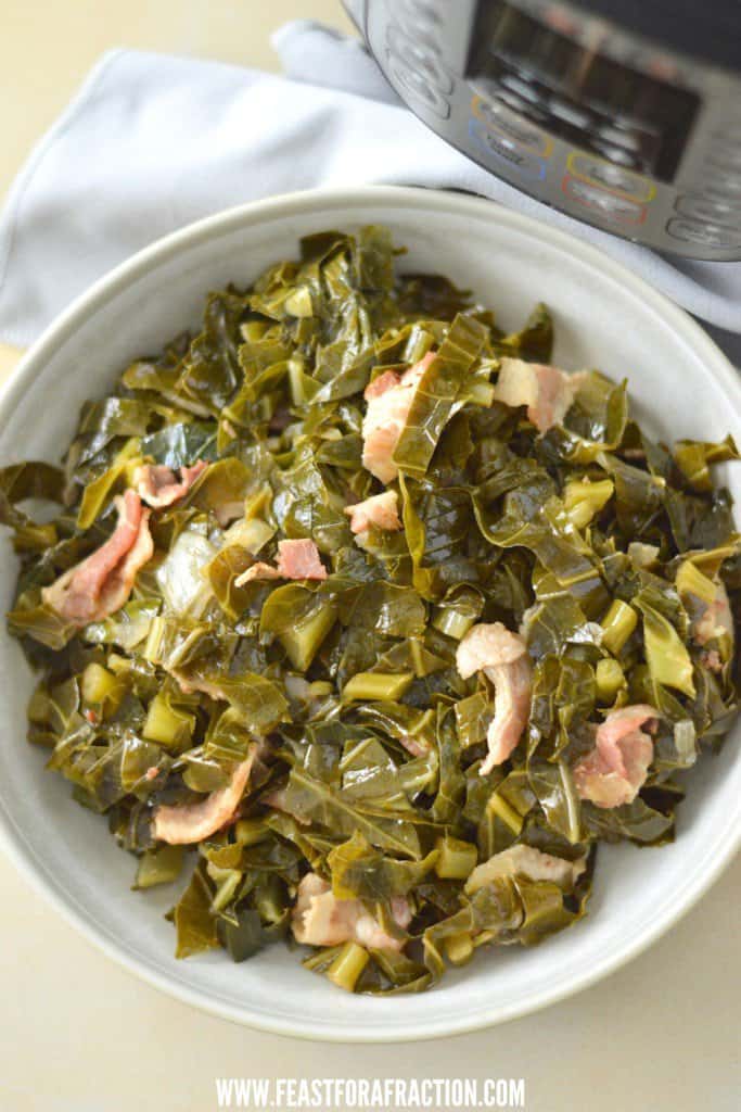 A bowl of collard greens and bacon in front of an instant pot.