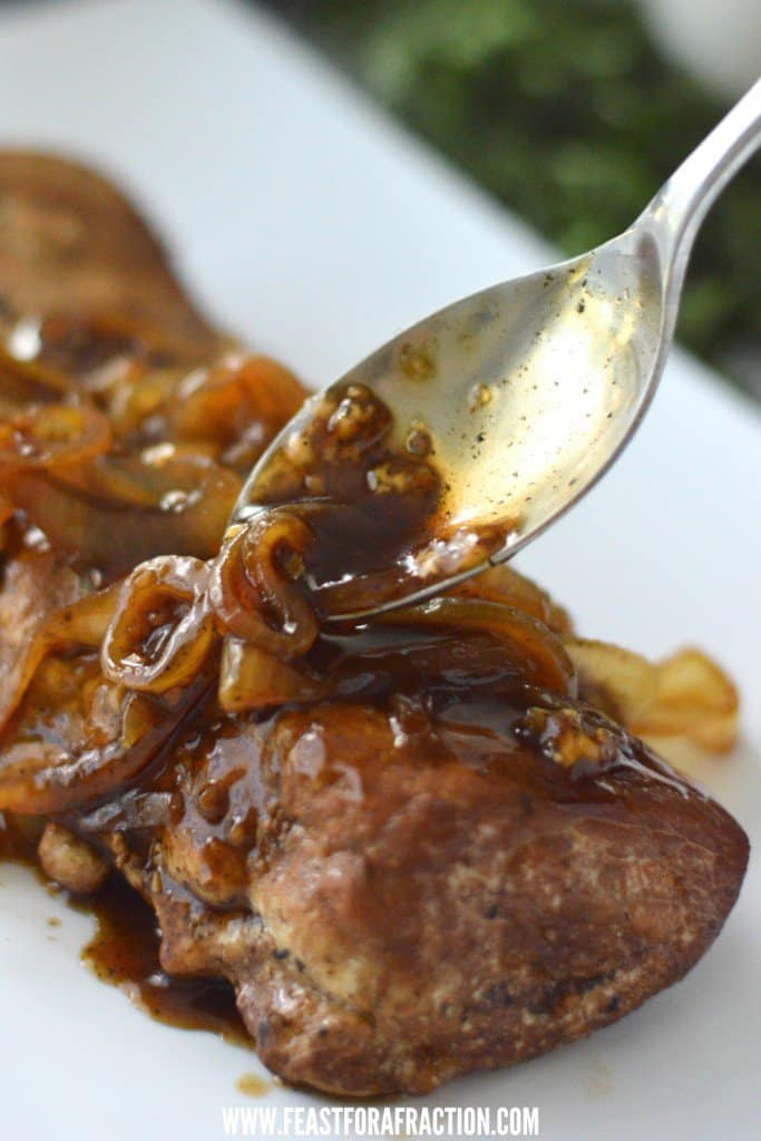 brown sugar balsamic sauce poured over slow cooker pork loin on white platter