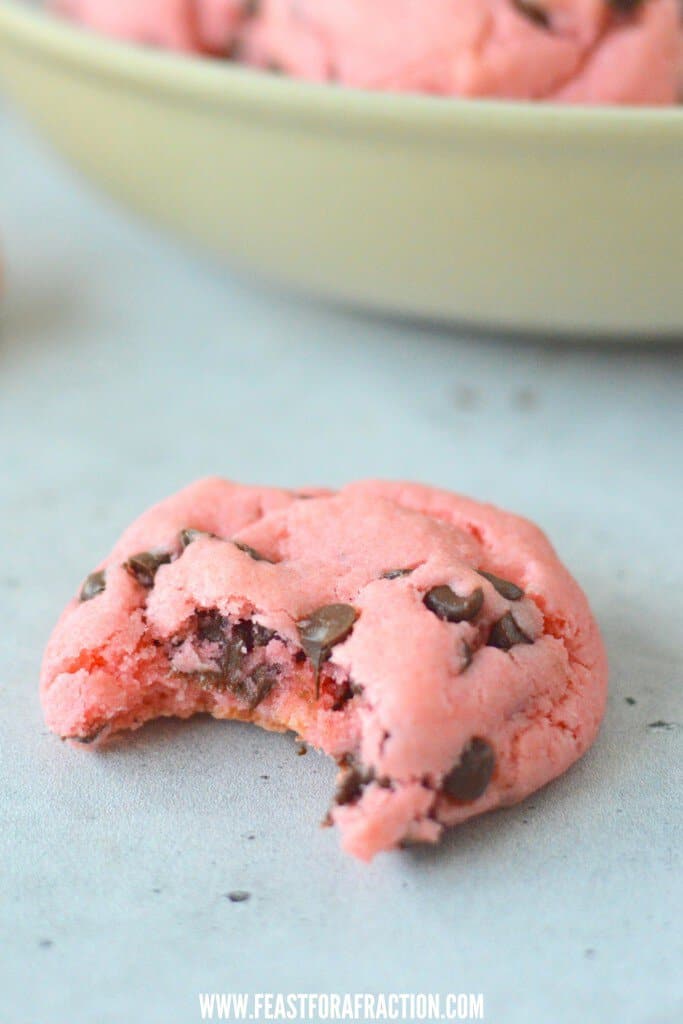 strawberry chocolate chip cookie with a bite taken out of them.