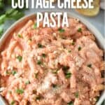 Bowl of pasta with cottage cheese and tomato sauce garnished with herbs and title text