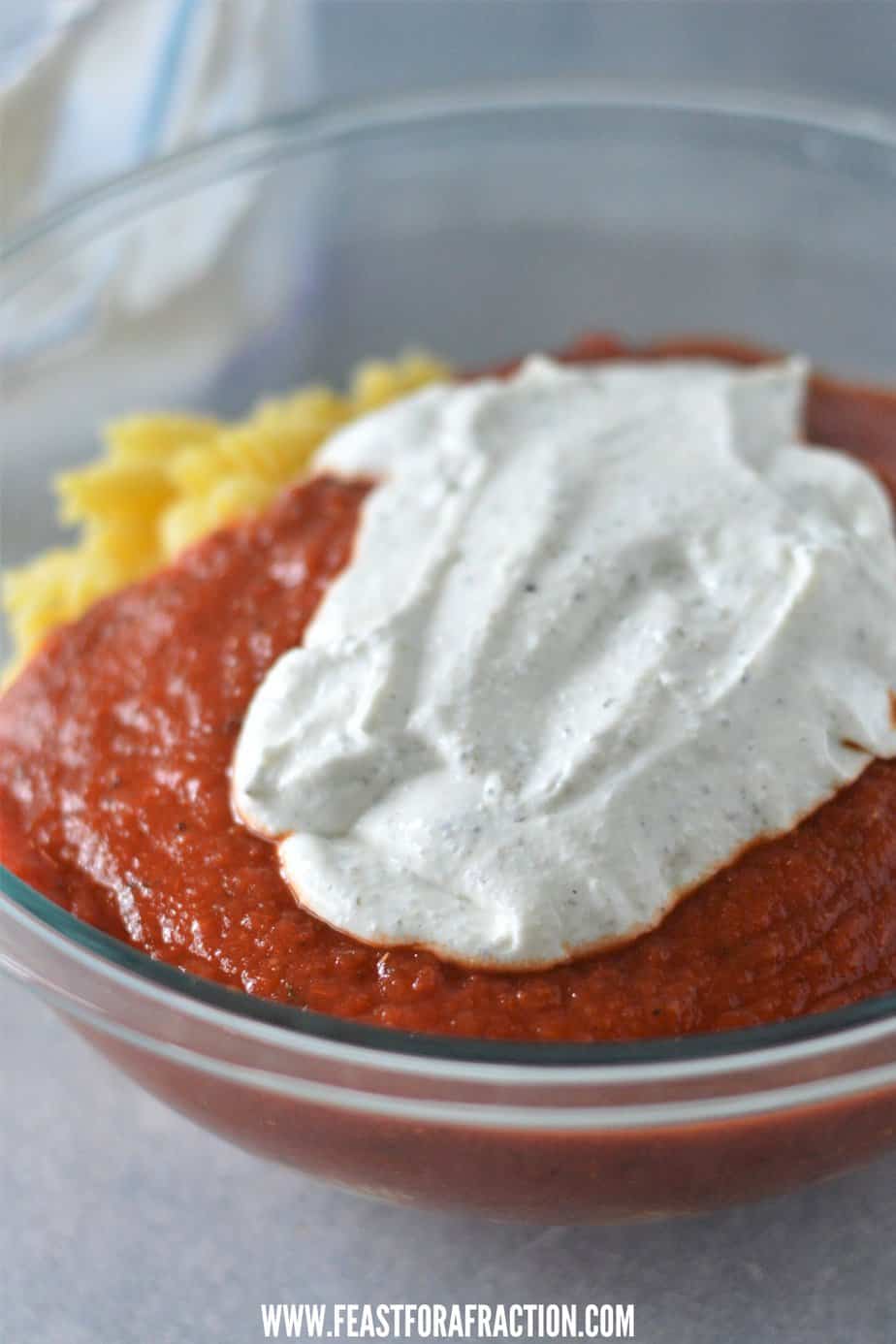 cooked pasta, marinara sauce and blended cottage cheese in glass bowl