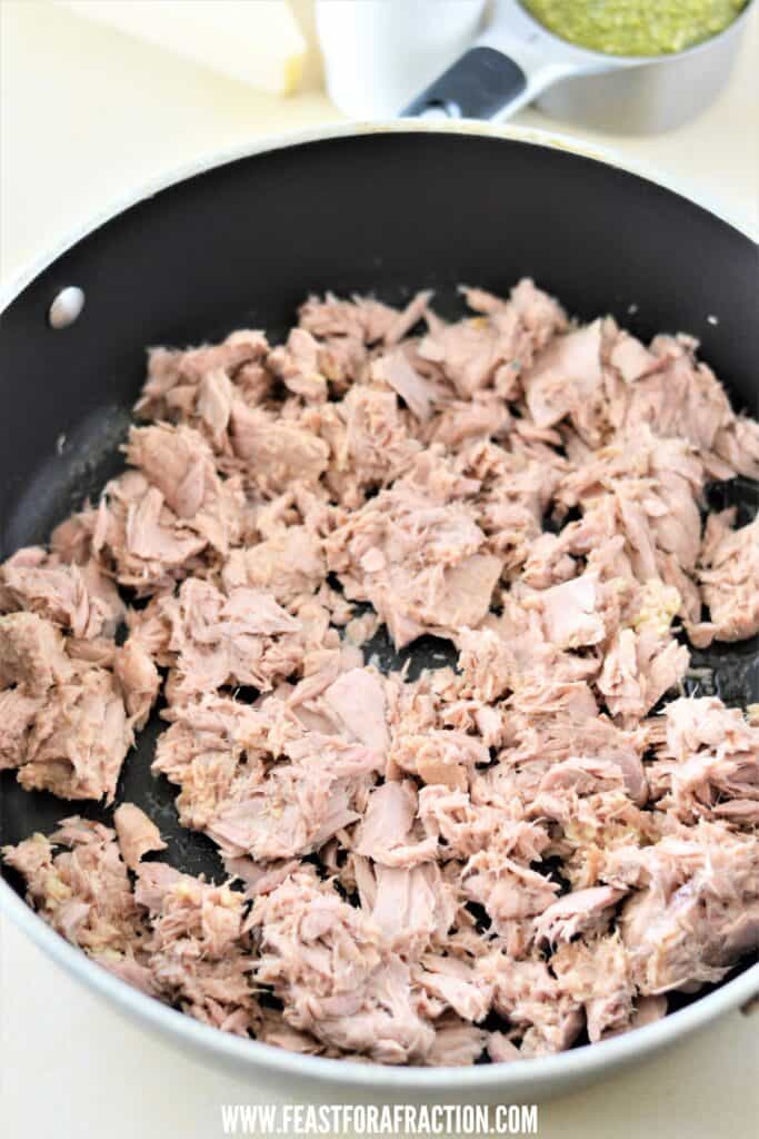 flaked canned tuna and minced garlic in skillet