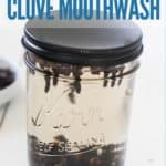 Jar of homemade clove mouthwash on a counter with title text