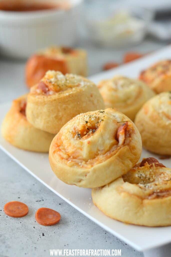 pizza crescent pinwheels on square white platter